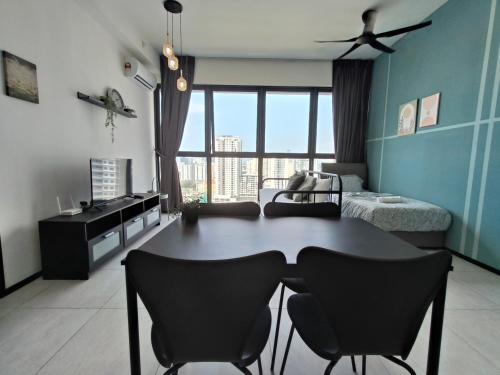 a room with a table and chairs and a bedroom at New 2BR or 3BR Homey Getaway stay 7 to 10 pax at Urban Suites, Georgetown by URBAN STAYCATION LOD in Jelutong
