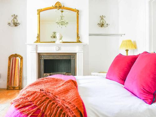 博格諾里吉斯的住宿－Seaside Retreat，一间卧室配有一张带粉红色枕头和镜子的床