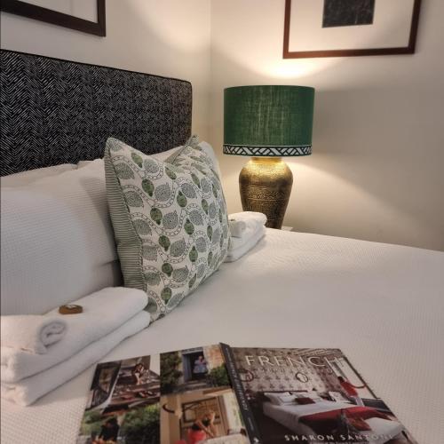a bed with a pillow and a magazine on it at Edward Lodge New Fam in Brisbane