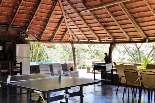 a patio with tables and chairs and a piano at Leopards Ledge in Nelspruit