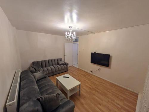 a living room with a couch and a tv at 2 Bedrooms. London Skyline view 3 beds and balcony in London