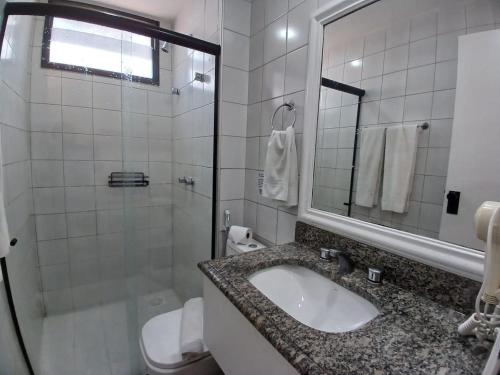 a bathroom with a sink and a shower and a toilet at Saint Martin By Escala Imóveis in Fortaleza