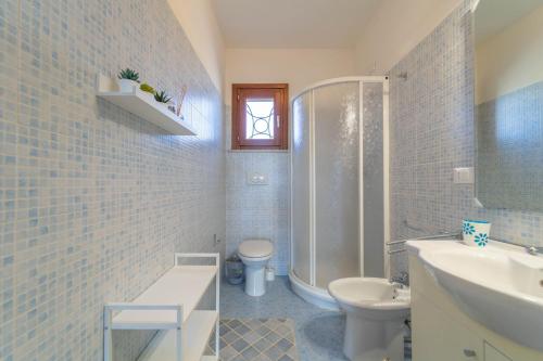 a bathroom with a sink and a toilet and a shower at Voilier 28 by DomusAway in Olbia
