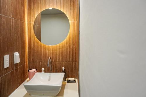 a bathroom with a sink and a mirror at Dongseongro ZERO guesthouse in Daegu