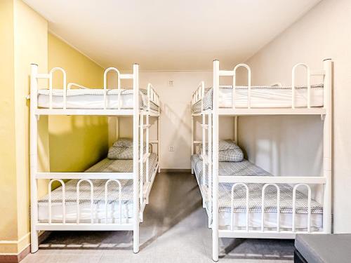 a room with three bunk beds in a house at Dongseongro ZERO guesthouse in Daegu