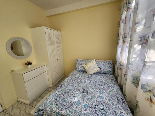 a small bedroom with a bed and a mirror at Sun Lover's Apartments in The Lime