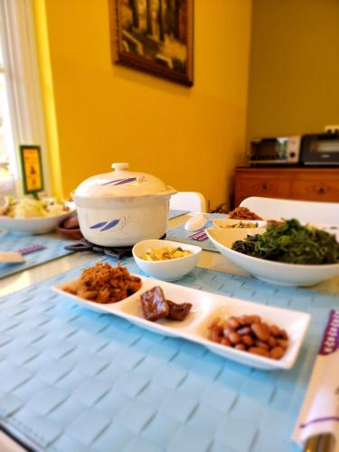 a table with many plates of food on it at 干城小鎮民宿-包棟-寵物友善 in Jian