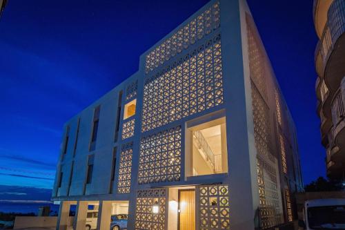 a building with lights on the side of it at 恩納オーシャンビュースイート in Nakadomari