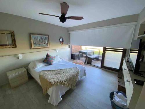 a bedroom with a bed and a ceiling fan at Apartamento Terrazas de Manantiales frente al mar in Punta del Este