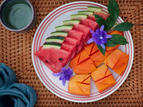 a plate of fruit with a slice of watermelon and vegetables at The Canopy Krabi in Ao Nang Beach