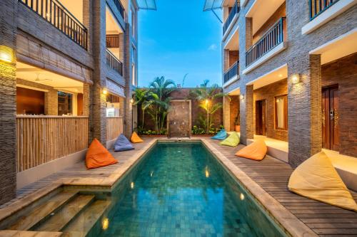 a swimming pool in the middle of a house at Gelatik Bed And Breakfast in Seminyak