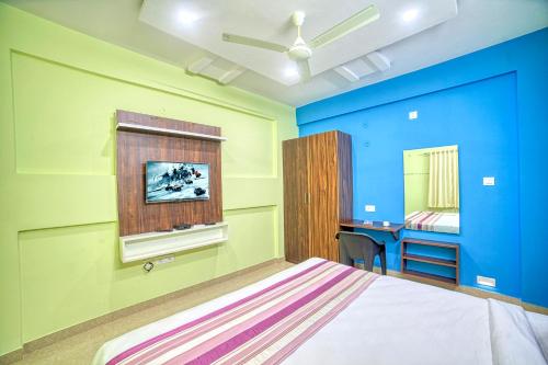 RedKEY Inn Bangalore Airport - Pick up & Drop Available 24x7 في Yelahanka: غرفة نوم بجدران زرقاء وأخضر وسرير