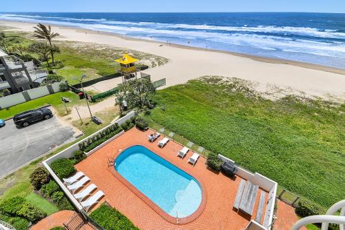 an overhead view of a swimming pool and the beach at Albatross North Apartments in Gold Coast