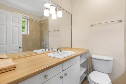 a bathroom with a sink and a toilet and a mirror at Paradise Six in Creek Village