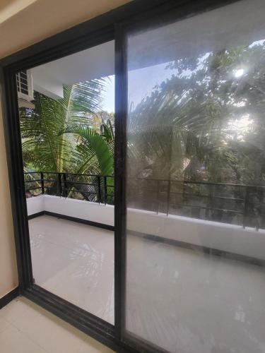 a window with a view of a balcony at hotel ramdev in Arambol