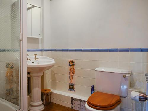 a bathroom with a toilet and a sink at Barn Suite in Beaconsfield