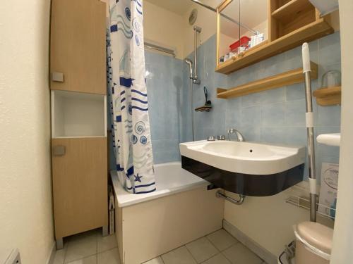 a bathroom with a sink and a shower curtain at Studio Crest-Voland, 1 pièce, 4 personnes - FR-1-733-153 in Crest-Voland