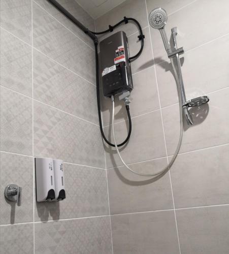 a shower in a bathroom with a shower head at Auliya Homestay Melaka Seaview Pantai Puteri in Melaka