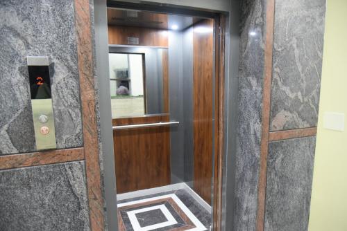 a door in a building with a mirror at The Paradise Guest Inn in Nellore