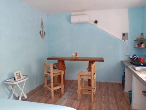 a small kitchen with a table and two chairs at El Puente in El Paredón Buena Vista
