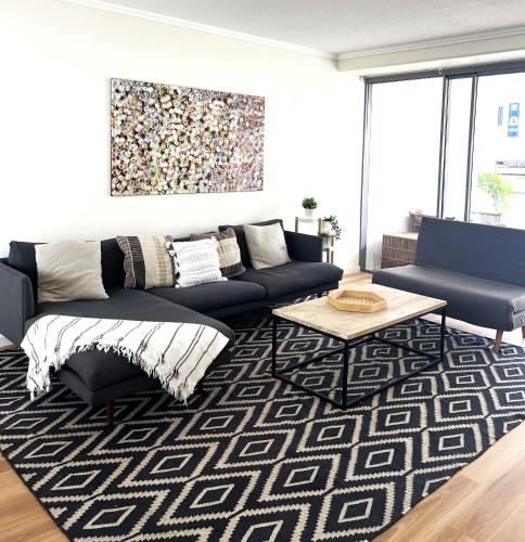 a living room with a couch and a rug at Perfect Locale 2bed Apt Parking in Brisbane