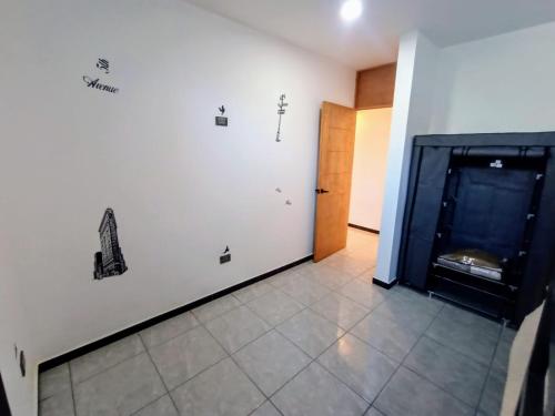 a room with a white wall with drawings on it at Departamento Nuevo Suite Máster in Aguascalientes