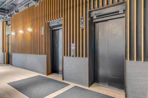 a row of elevator doors in a building at Modern King's Cross Apartments in London
