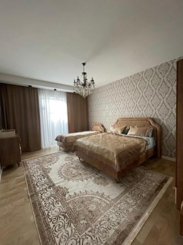 a bedroom with two beds and a rug at Дом у моря Мардакане in Mardakan