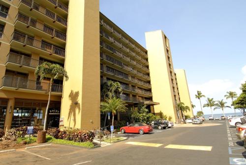 a parking lot in front of a large building at Mana Kai Maui - Official Onsite Rental Company in Wailea
