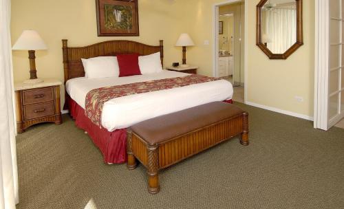 a bedroom with a large bed and two night stands at Mana Kai Maui - Official Onsite Rental Company in Wailea