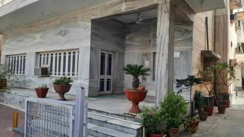 a house with potted plants on the front of it at Hotel Prithviraj in Ajmer