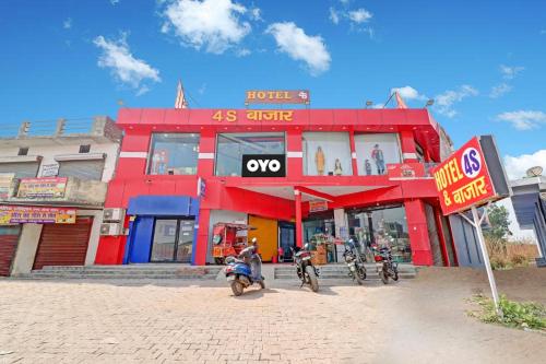 un edificio rojo con motocicletas estacionadas frente a él en OYO Hotel Four S, en Haridwar
