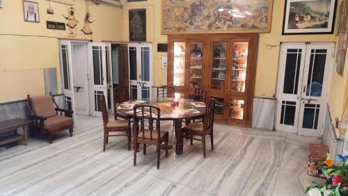 a dining room with a table and chairs at Hotel Prithviraj in Ajmer