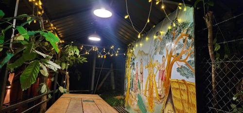 a room with a painting on the wall with lights at TREE6 WAYANAD in Vythiri