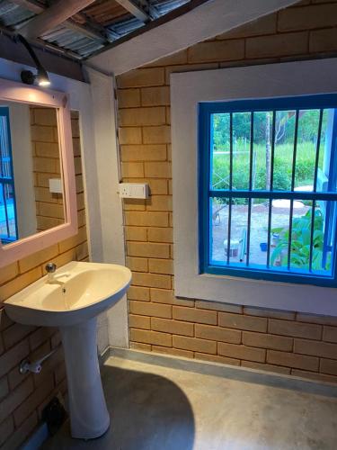 a bathroom with a sink and a window at Summer Bell Midigama in Midigama