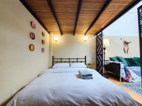 a bedroom with a large bed and a large window at Shanghai Hills & Zinn Happy Family Bnb in Shanghai