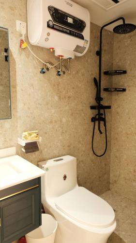 a bathroom with a white toilet and a shower at Shanghai Hills & CoZy Roof House in Shanghai