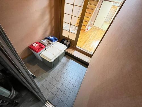 an overhead view of a living room with a couch with luggage at 最大８人様まで宿泊可能な１棟貸しです！近鉄八尾駅から徒歩３分！ in Yaochō