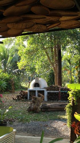 a stone oven in a park with trees at Navari Homestay in Rayong