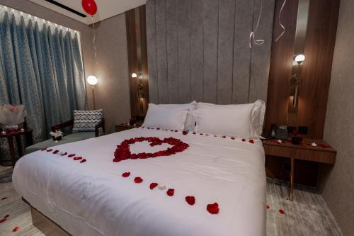 a bed with a heart made out of red roses at Damask Hotels in Al Hada