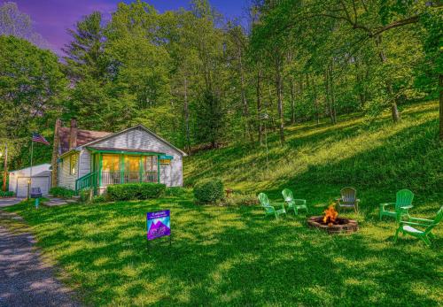 a house with a yard with a fire in the grass at Hillside Hideaway in Logan