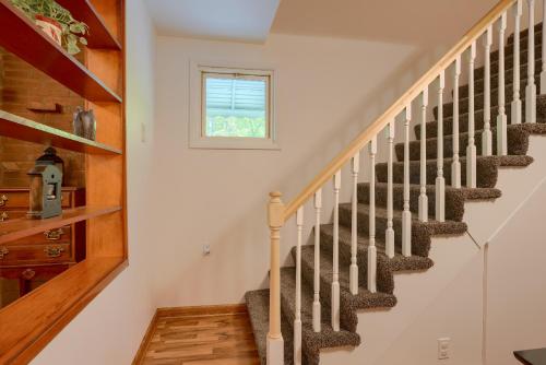 a staircase in a home with white walls and wood floors at Hillside Hideaway in Logan