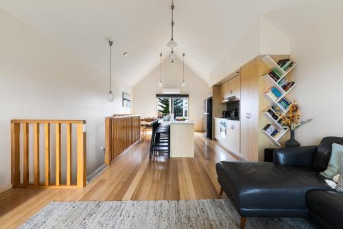 a living room with a couch and a kitchen at The Dunes in Ocean Grove