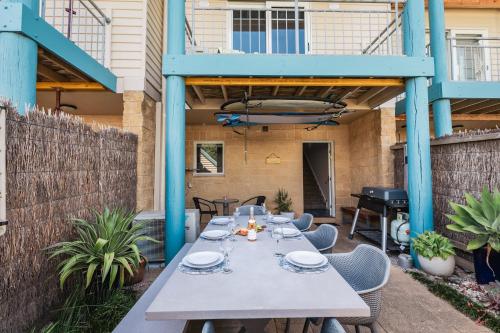 a patio with a table and chairs and a piano at The Dunes in Ocean Grove