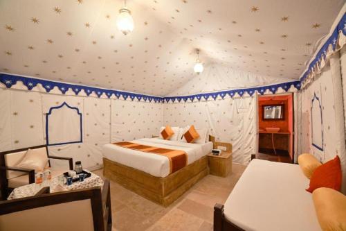 a bedroom with a bed in a room with stars on the walls at Ozaki Desert Camp in Jaisalmer