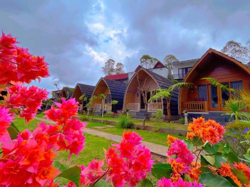 una fila de casas con flores en primer plano en Batur cottage, en Kubupenlokan