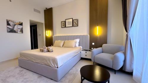 a hotel room with a bed and a chair at Luxury, One bedroom apartment Ocean view in Ras al Khaimah