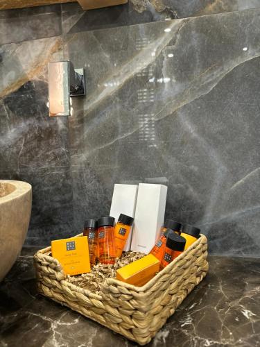 a basket of essential oils on a counter in a bathroom at V Chalet Residence in Velingrad
