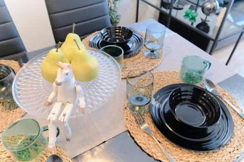 a table with two plates and a toy horse on it at EveryNet ShinjukuⅡ in Tokyo