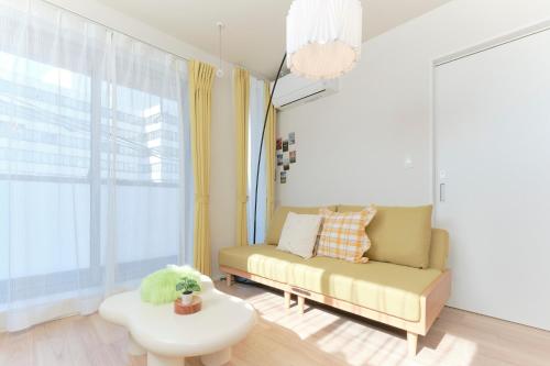 a living room with a couch and a coffee table at EveryNet ShinjukuⅡ in Tokyo